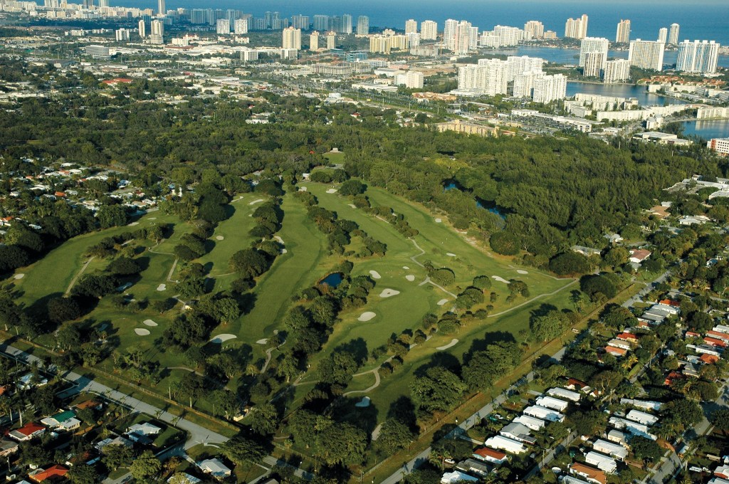 Aerial view of golf course with Miami beach in background